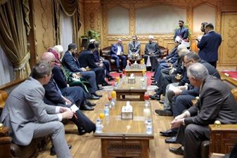 Image may contain: one or more people, people sitting and indoor